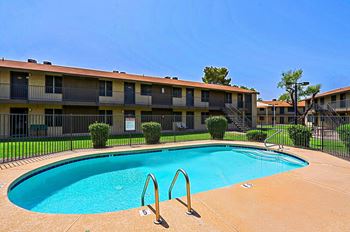 A swimming pool in front of apartment buildings at Sahuaro West, Phoenix, AZ
